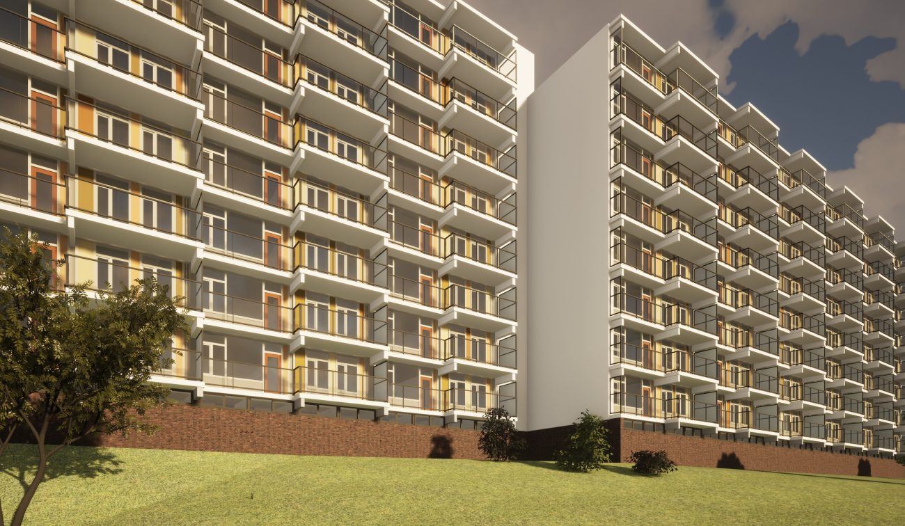 Impressie lange flatgevel met ritmische balkons en glazen borstweringen boven bakstenen plint — Groot onderhoud Albert Schweitzer Brunssum