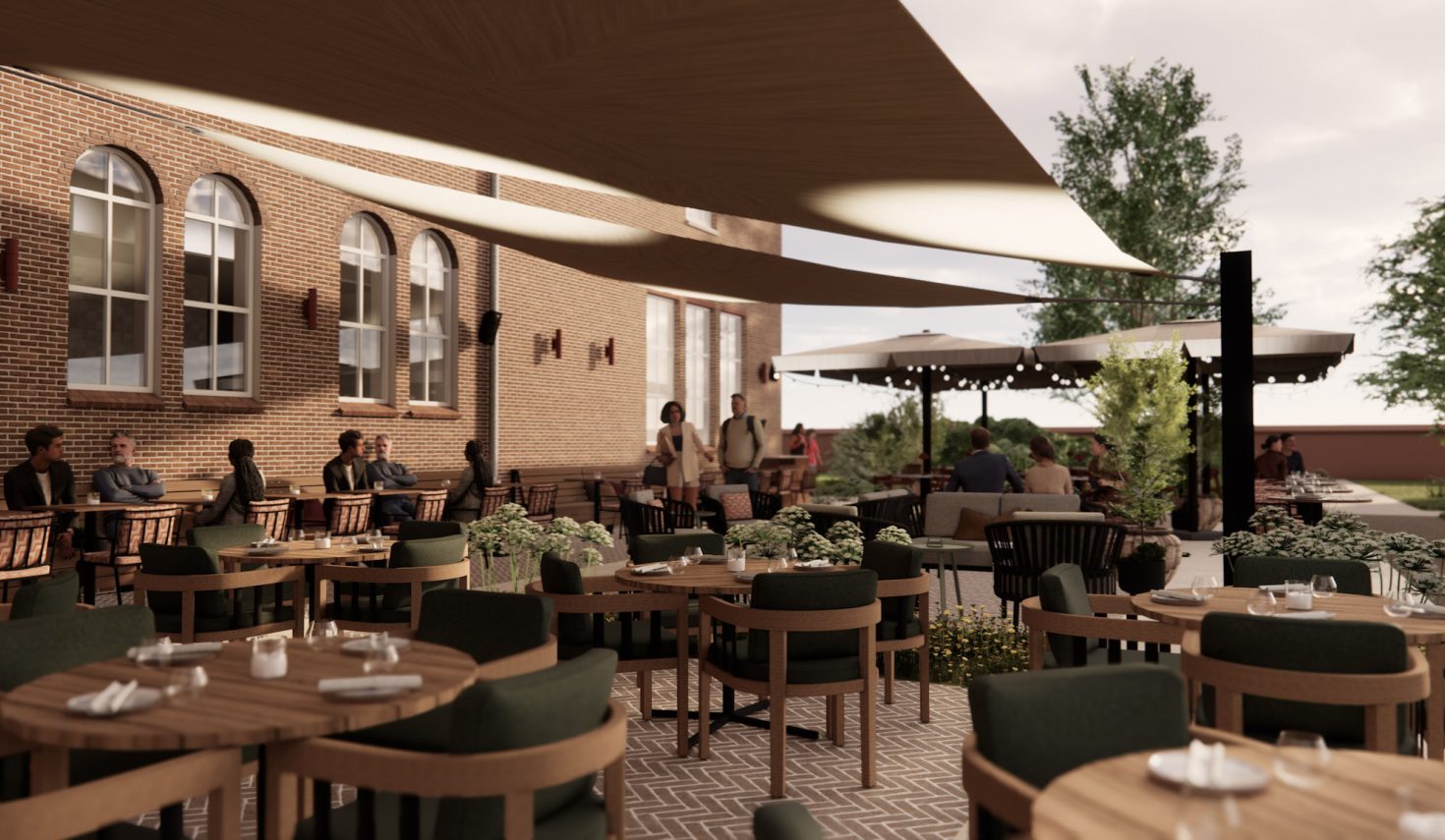 Impressie Hotel Clara Eindhoven – terras met schaduwdoeken, bakstenen gevel, groen en sfeerverlichting