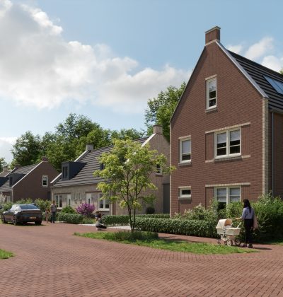Vrijstaande bakstenen woningen in Bosrijk Mariendaal (Velp) langs rood klinkerwegdek; groenstroken, geparkeerde auto’s en wandelaar met kinderwagen, zonnige dag.