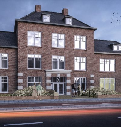 Impressie van de nieuwbouwkazerne in Helmond tijdens de avond, met verlichte gevel en mensen die langs het gebouw lopen.