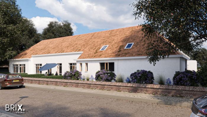 Transformatie oude school Buchten: wit gepleisterd gebouw met oranjerode pannen, lage muur en beplanting